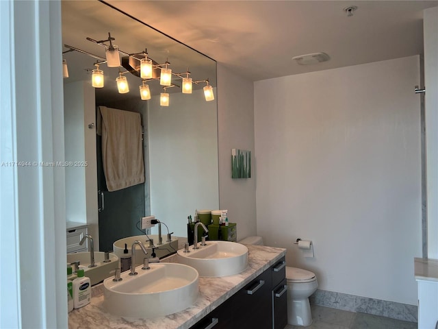 bathroom featuring toilet, vanity, and tile patterned floors