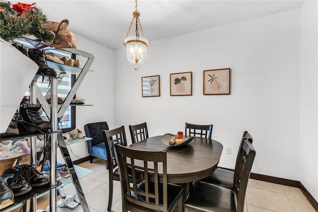 dining room with baseboards and light tile patterned flooring