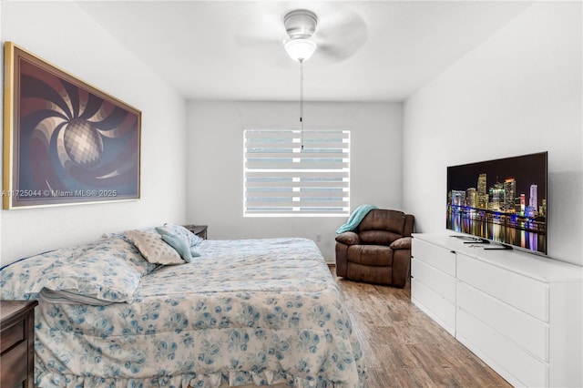 bedroom with light wood finished floors and a ceiling fan