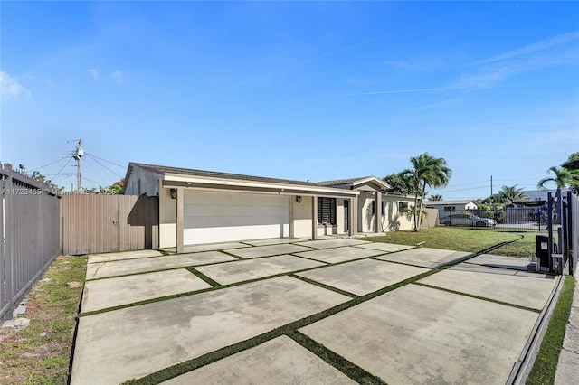 ranch-style house featuring a garage and a front yard