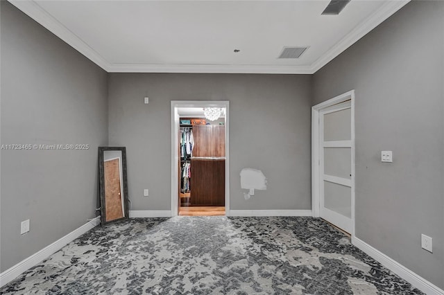 unfurnished room featuring crown molding