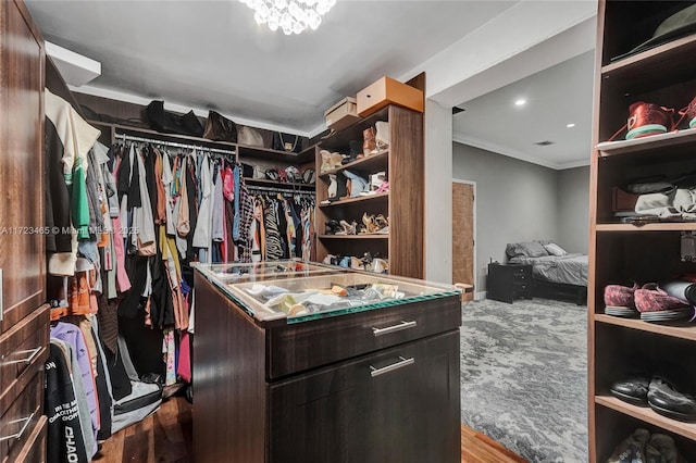 walk in closet with light hardwood / wood-style floors