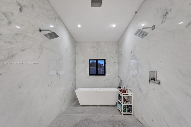 bathroom with a bathing tub and tile walls