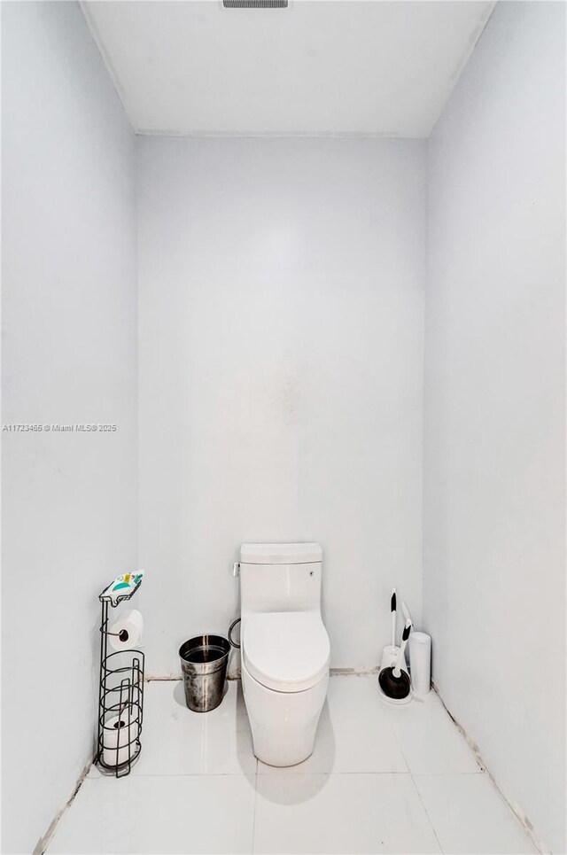 bathroom with tile patterned flooring and toilet