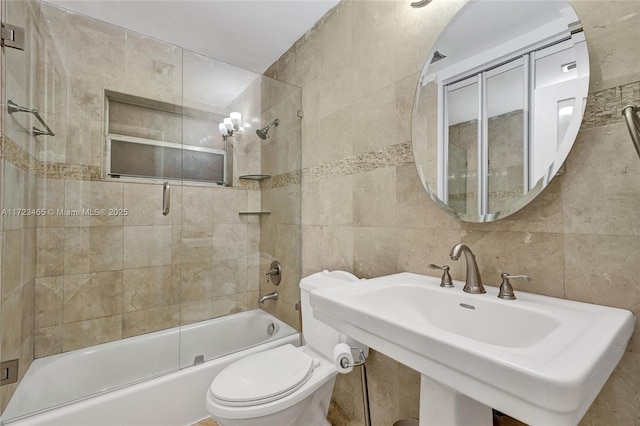 full bathroom with toilet, sink, shower / bath combination with glass door, tile walls, and backsplash