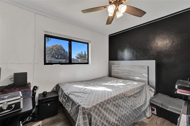 bedroom featuring hardwood / wood-style flooring and ceiling fan