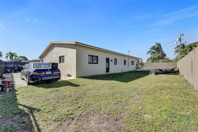 view of side of property featuring a yard