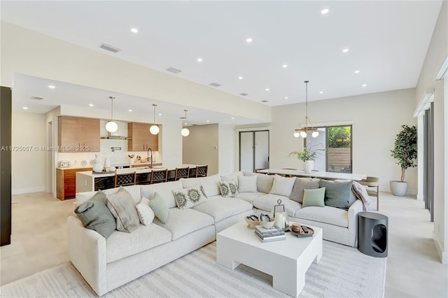 living room featuring recessed lighting, visible vents, and baseboards