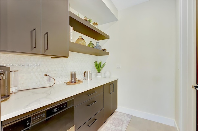 interior space featuring baseboards, decorative backsplash, dishwasher, light stone countertops, and open shelves