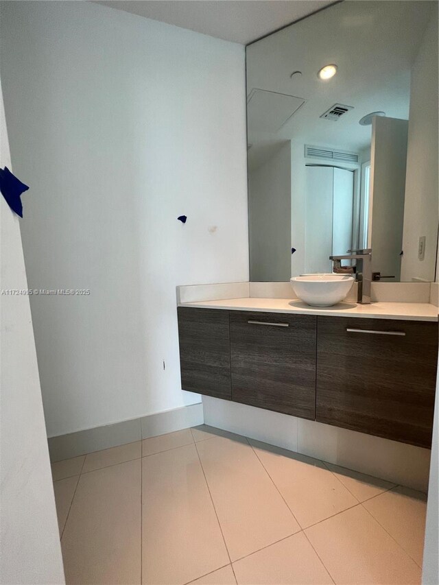 bathroom with tile patterned flooring and vanity