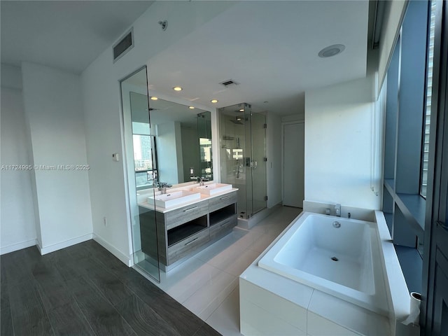 bathroom featuring vanity and plus walk in shower