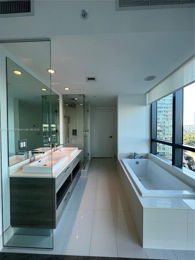 bathroom with vanity, tile patterned floors, and separate shower and tub