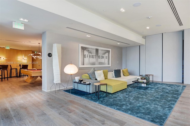 living room featuring hardwood / wood-style floors and pool table