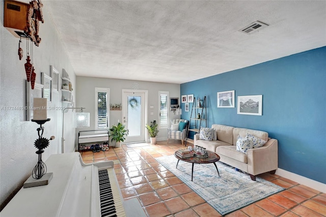 tiled living room with a textured ceiling