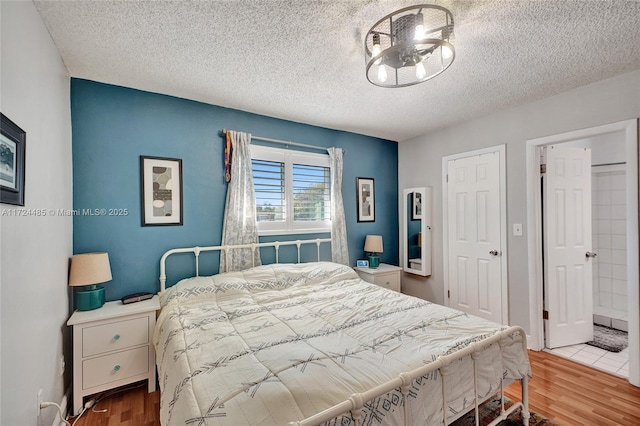 bedroom featuring hardwood / wood-style floors and a textured ceiling