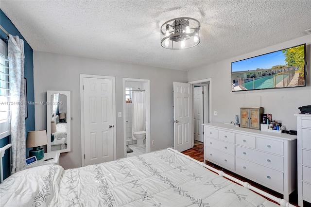 bedroom with a textured ceiling and connected bathroom