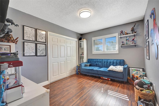 living room with dark hardwood / wood-style flooring and a textured ceiling