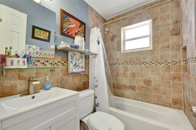 full bathroom with vanity, shower / bath combination with curtain, tile walls, and toilet