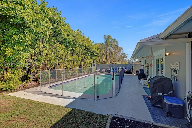 view of swimming pool with a grill and a patio