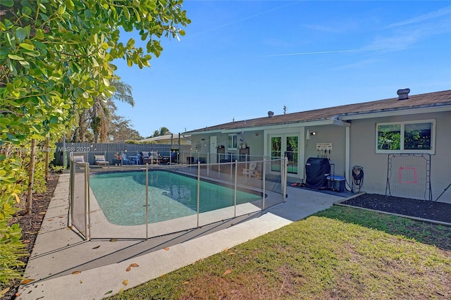 view of swimming pool featuring a lawn and a patio area