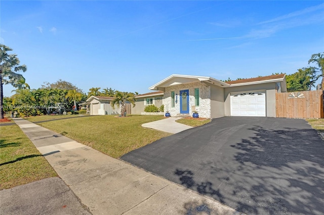 view of front of property featuring a garage and a front lawn