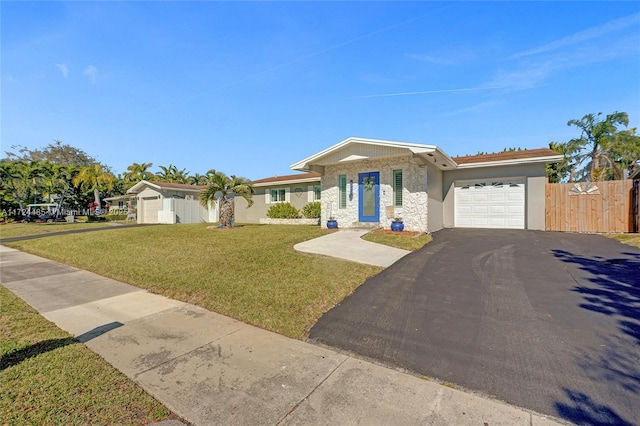 view of front of property featuring a garage and a front lawn