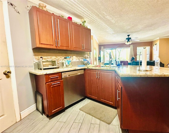 kitchen featuring kitchen peninsula, stainless steel dishwasher, ceiling fan, and light stone counters