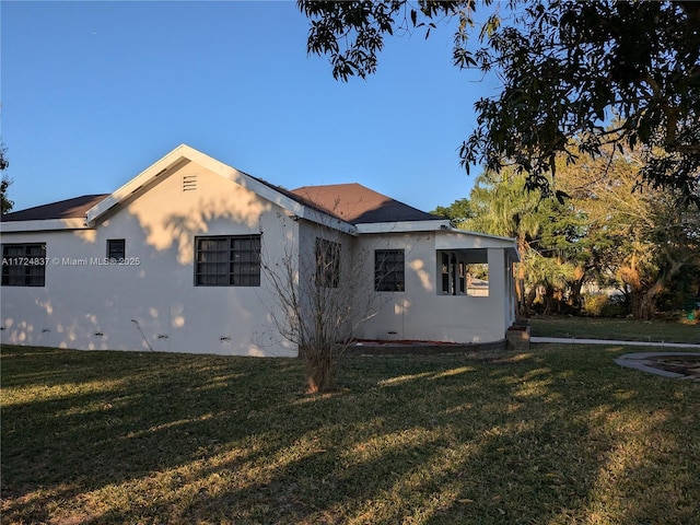 view of side of home featuring a yard