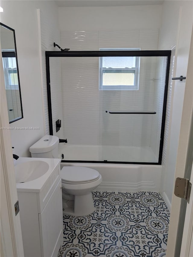 full bathroom featuring tile patterned flooring, vanity, enclosed tub / shower combo, and toilet