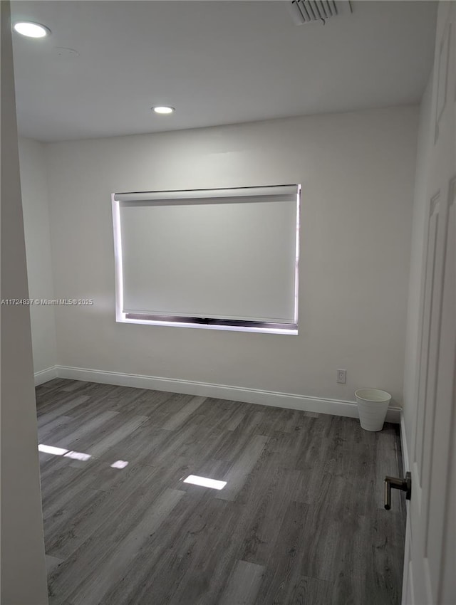 unfurnished room with dark wood-type flooring