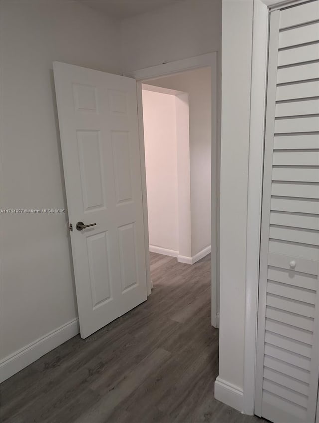 hallway with dark hardwood / wood-style floors