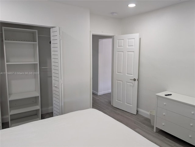 bedroom featuring dark hardwood / wood-style floors and a closet