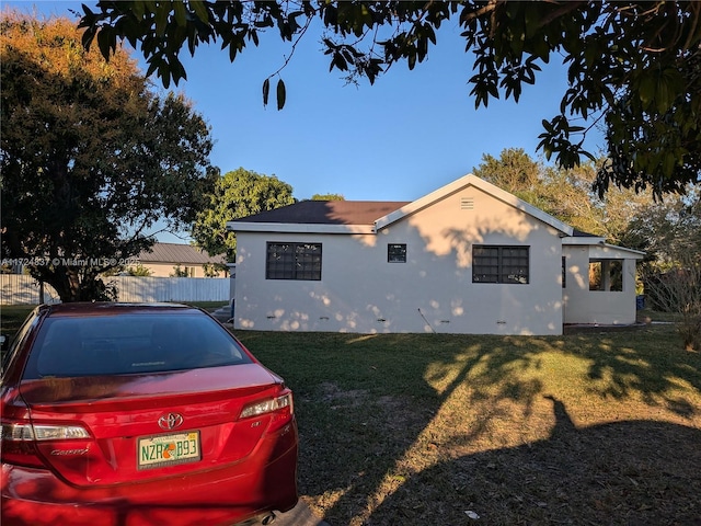 view of side of property with a yard