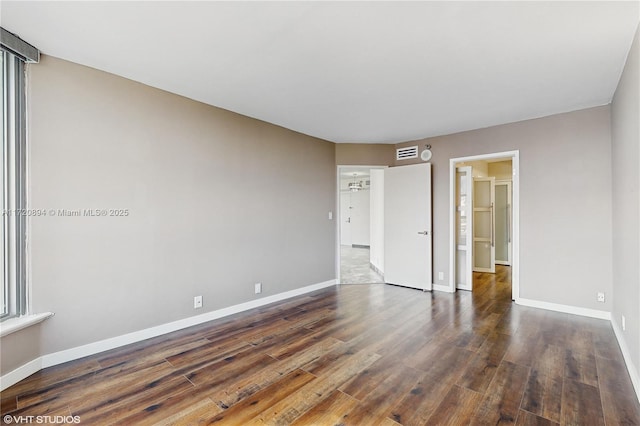 spare room with dark hardwood / wood-style flooring