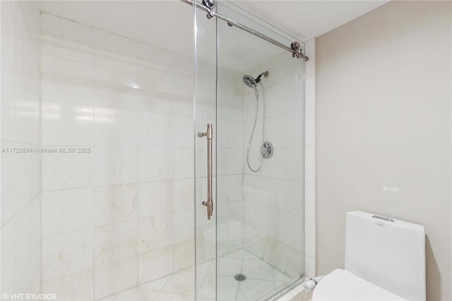 bathroom with an enclosed shower and toilet