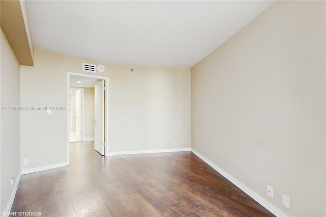 spare room featuring dark hardwood / wood-style floors