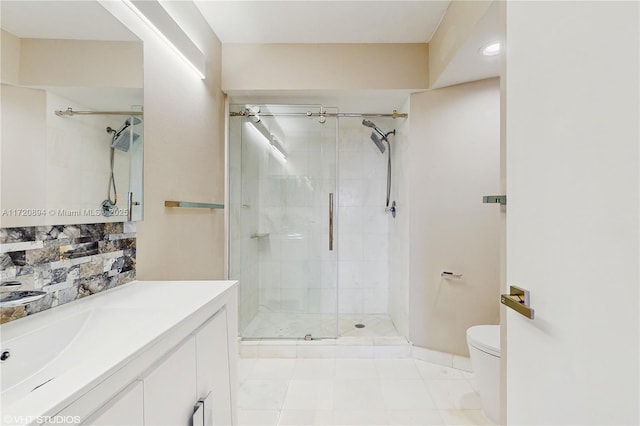 bathroom featuring tile patterned flooring, vanity, walk in shower, and toilet