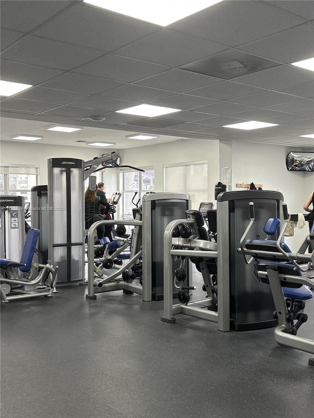 gym with a wealth of natural light and a paneled ceiling