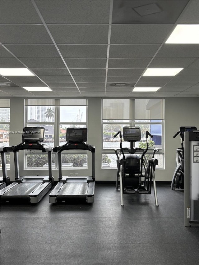 gym featuring a wealth of natural light and a paneled ceiling