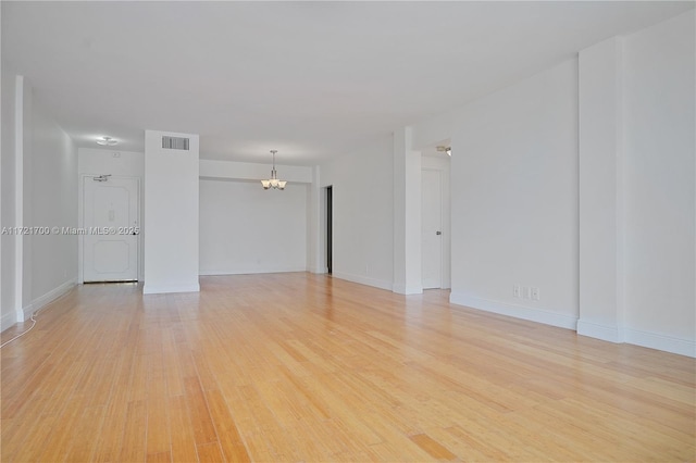 9381 E Bay Harbor Dr Unit 301N, Bay Harbor Islands, FL 33154 - empty room with a chandelier, light wood-style flooring, and baseboards