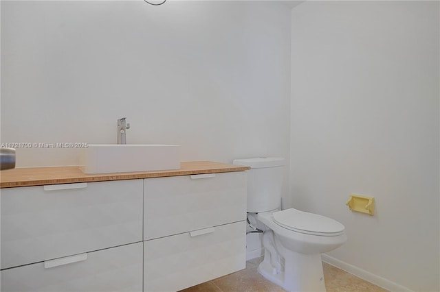 9381 E Bay Harbor Dr Unit 301N, Bay Harbor Islands, FL 33154 - bathroom with baseboards, toilet, vanity, and tile patterned floors