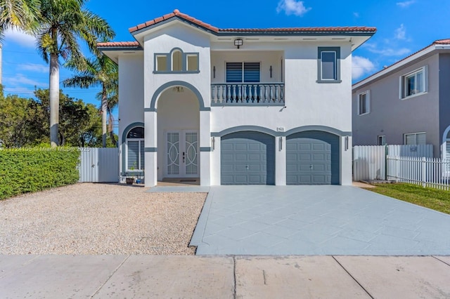 mediterranean / spanish house featuring a balcony and a garage