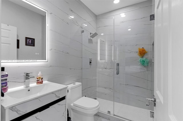 bathroom with toilet, an enclosed shower, and vanity