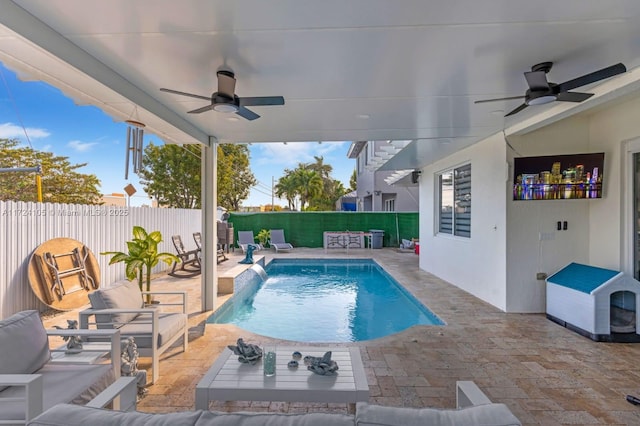 view of pool featuring pool water feature, ceiling fan, and a patio