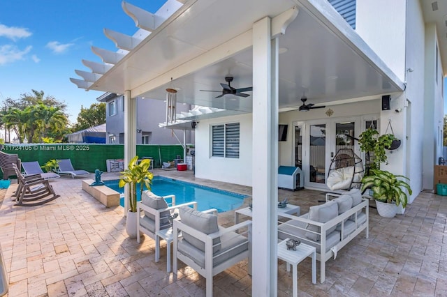 view of swimming pool with ceiling fan, french doors, and a patio