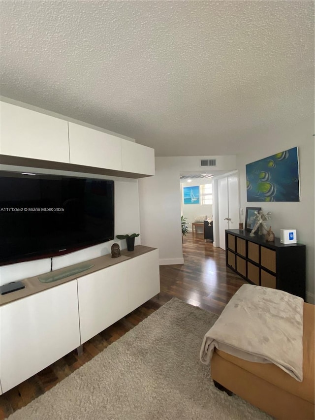 2278 SE 27th Dr Unit 201-G, Homestead, FL 33035 - bedroom with a textured ceiling and dark wood-type flooring