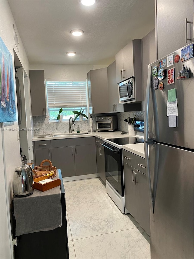 2278 SE 27th Dr Unit 201-G, Homestead, FL 33035 - kitchen with backsplash, stainless steel appliances, gray cabinetry, and sink