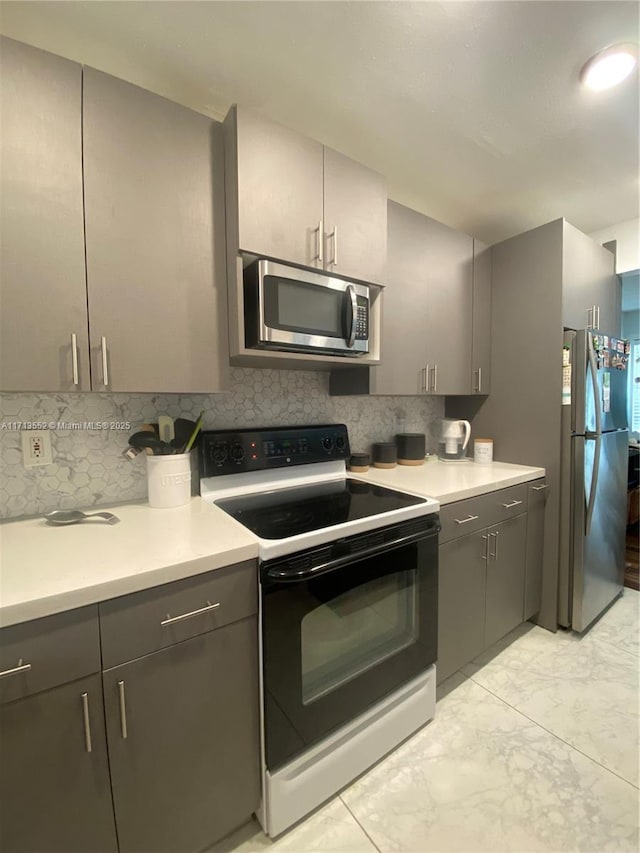 2278 SE 27th Dr Unit 201-G, Homestead, FL 33035 - kitchen featuring stainless steel appliances, tasteful backsplash, and gray cabinetry