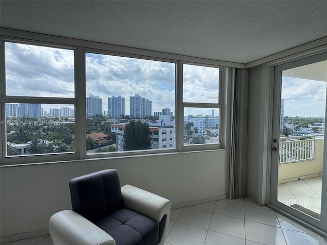 3180 S Ocean Dr Unit 721, Hallandale Beach, FL 33009 - sitting room featuring tile patterned floors, a city view, a textured ceiling, and baseboards