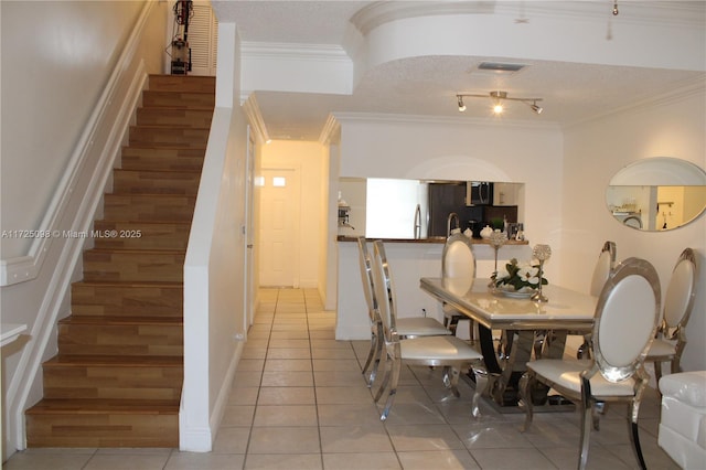 dining room with stairway, light tile patterned floors, visible vents, and ornamental molding